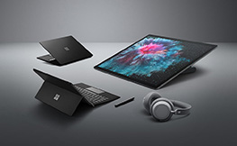 Photo of Microsoft Surface Studio II, Surface Pro 6 and Surface Laptop with headphones and stylus.